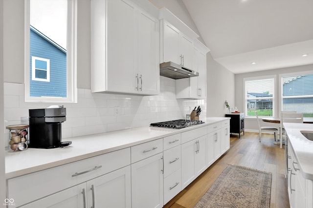 15744 Kohut Ln, Westfield, IN 46074 - kitchen featuring stainless steel gas cooktop, range hood, light wood-type flooring, white cabinetry, and light countertops