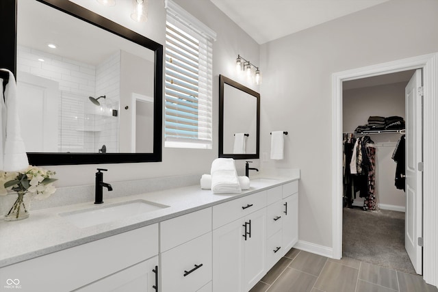 15744 Kohut Ln, Westfield, IN 46074 - full bathroom featuring double vanity, tiled shower, and a walk in closet