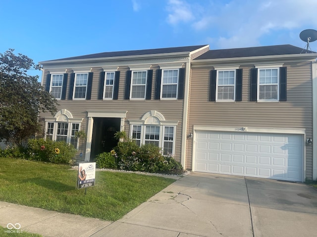 12583 Courage Xing, Fishers, IN 46037 - view of front facade featuring concrete driveway, a front lawn, and a garage