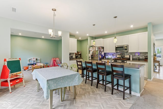 1022 Cyprian Way, Lebanon, IN 46052 - kitchen featuring appliances with stainless steel finishes, dark countertops, backsplash, white cabinetry, and recessed lighting