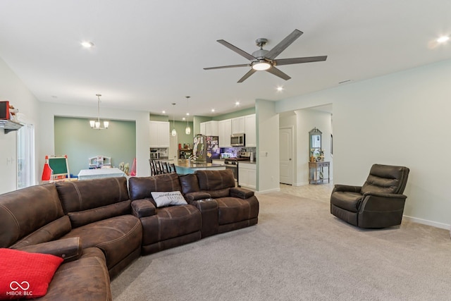 1022 Cyprian Way, Lebanon, IN 46052 - living area with light carpet, ceiling fan, a chandelier, and recessed lighting