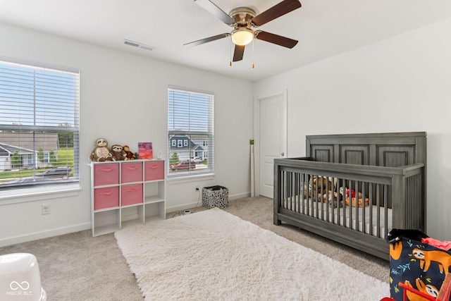 1022 Cyprian Way, Lebanon, IN 46052 - carpeted bedroom featuring a crib and a ceiling fan
