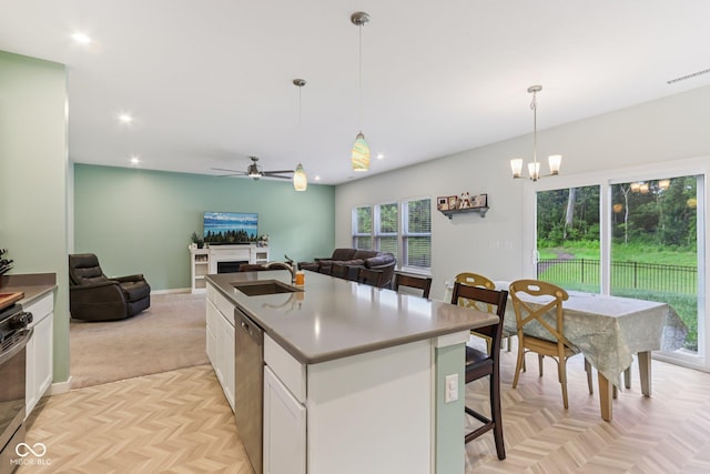 1022 Cyprian Way, Lebanon, IN 46052 - kitchen featuring open floor plan, appliances with stainless steel finishes, a ceiling fan, white cabinetry, and pendant lighting