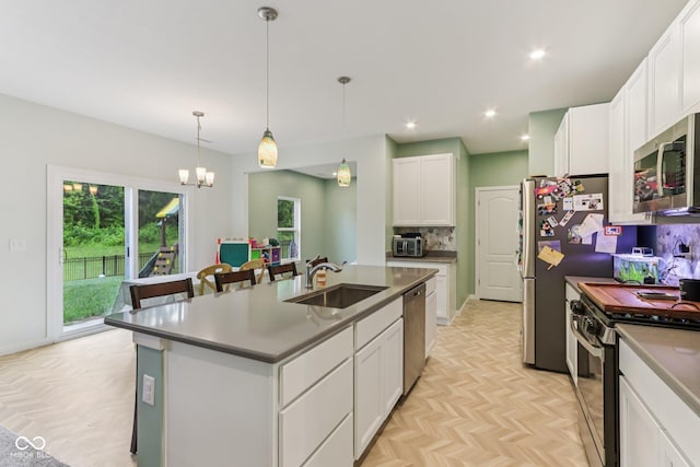 1022 Cyprian Way, Lebanon, IN 46052 - kitchen with appliances with stainless steel finishes, tasteful backsplash, an island with sink, white cabinets, and recessed lighting