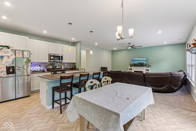 1022 Cyprian Way, Lebanon, IN 46052 - dining room with a ceiling fan, recessed lighting, and a chandelier