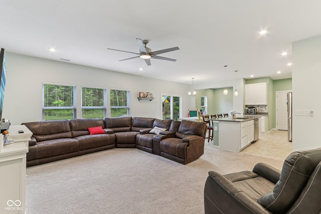 1022 Cyprian Way, Lebanon, IN 46052 - living room with light carpet, a ceiling fan, and recessed lighting
