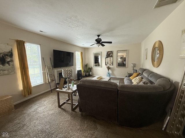 611 Crossfield Ct, Indianapolis, IN 46239 - carpeted living area featuring a ceiling fan, plenty of natural light, and a fireplace