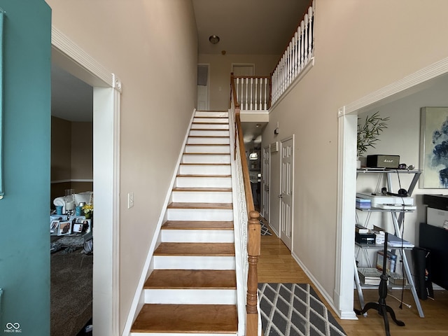 611 Crossfield Ct, Indianapolis, IN 46239 - staircase featuring wood finished floors and a towering ceiling