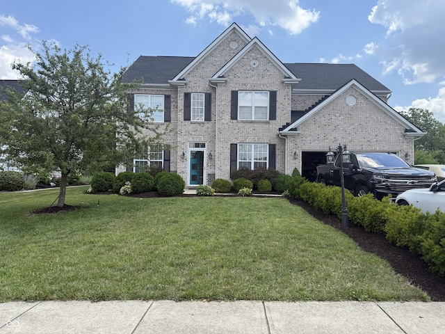 611 Crossfield Ct, Indianapolis, IN 46239 - view of front of house featuring brick siding, a front yard, and a garage