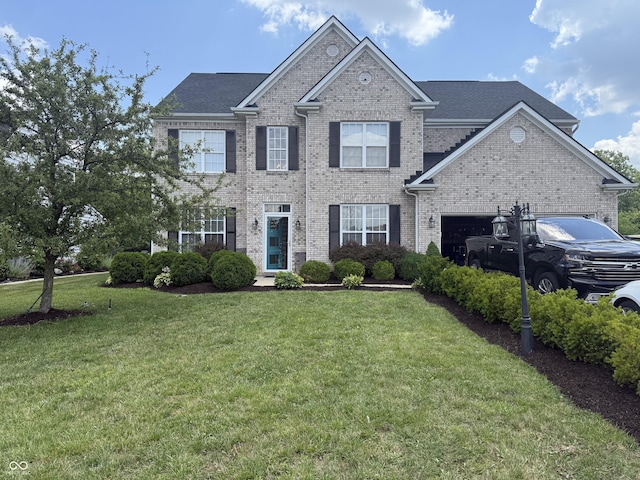 611 Crossfield Ct, Indianapolis, IN 46239 - view of front of home with brick siding, a front yard, and a garage