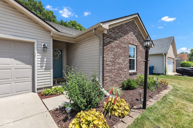 7702 Wood Stream Dr, Indianapolis, IN 46239 - property entrance with an attached garage, brick siding, a yard, and roof with shingles