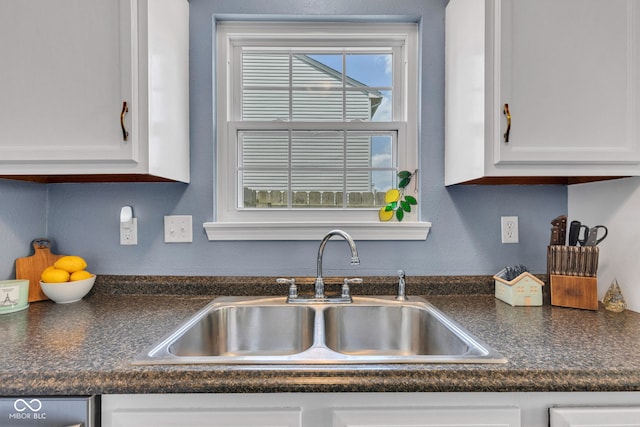 7702 Wood Stream Dr, Indianapolis, IN 46239 - kitchen with white cabinetry and dark countertops