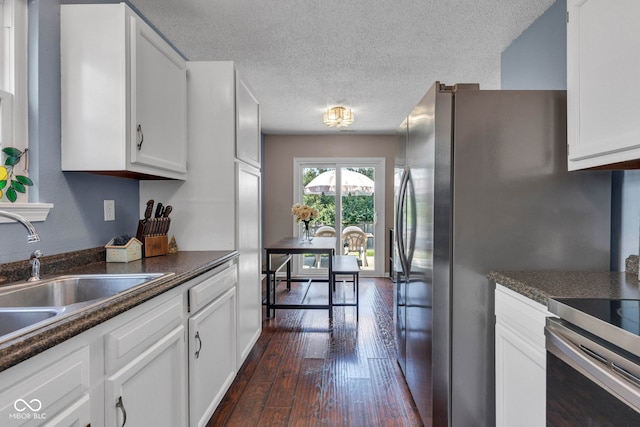 7702 Wood Stream Dr, Indianapolis, IN 46239 - kitchen featuring dark countertops, white cabinetry, dark wood-style flooring, a textured ceiling, and stainless steel range with electric cooktop