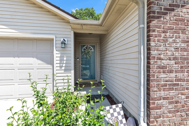 7702 Wood Stream Dr, Indianapolis, IN 46239 - entrance to property with an attached garage and brick siding