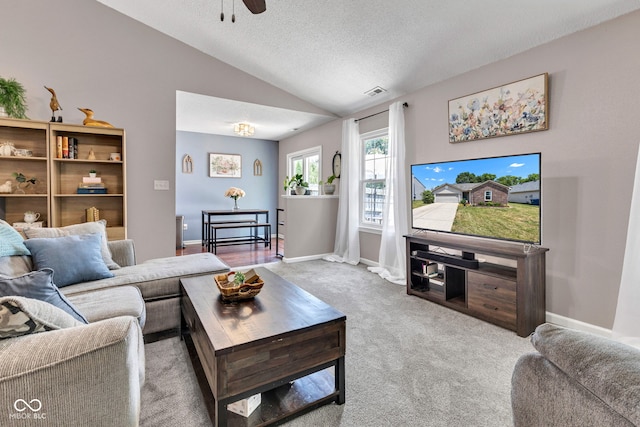 7702 Wood Stream Dr, Indianapolis, IN 46239 - carpeted living room featuring vaulted ceiling, a ceiling fan, and a textured ceiling