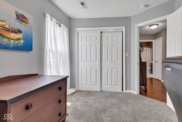 7702 Wood Stream Dr, Indianapolis, IN 46239 - bedroom featuring carpet flooring, a textured ceiling, and a closet