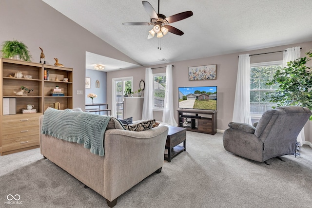 7702 Wood Stream Dr, Indianapolis, IN 46239 - living room featuring light colored carpet, lofted ceiling, a textured ceiling, and a ceiling fan