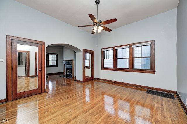 832 Noble St, Indianapolis, IN 46203 - unfurnished room with light wood-style floors, ceiling fan, and arched walkways