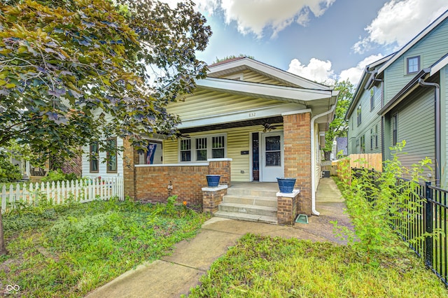 832 Noble St, Indianapolis, IN 46203 - view of front of property with a porch, brick siding, and ceiling fan