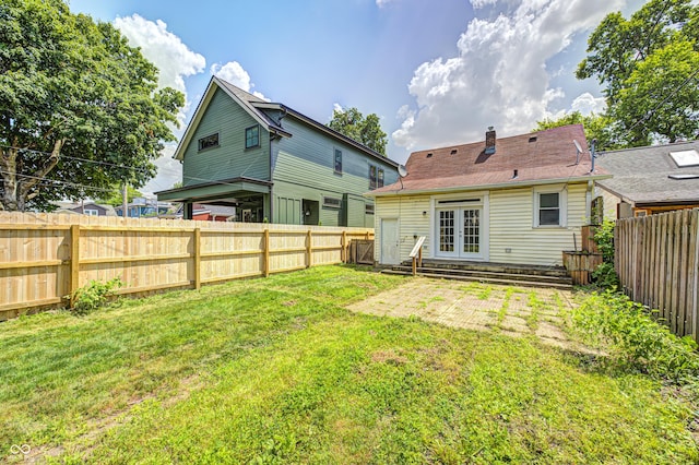 832 Noble St, Indianapolis, IN 46203 - back of property with french doors, entry steps, a fenced backyard, and a patio area