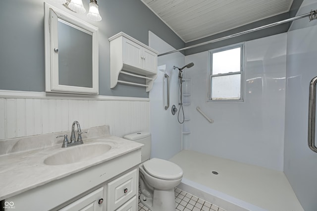 832 Noble St, Indianapolis, IN 46203 - full bathroom featuring a shower, vanity, a wainscoted wall, and tile patterned floors