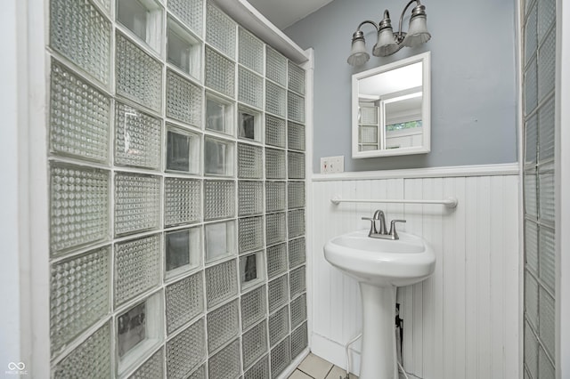 832 Noble St, Indianapolis, IN 46203 - full bath with a wainscoted wall, tile patterned flooring, and tiled shower