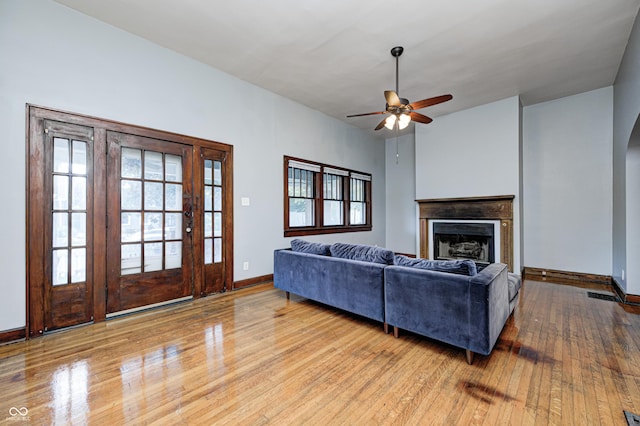 832 Noble St, Indianapolis, IN 46203 - living room with wood-type flooring, ceiling fan, arched walkways, and a fireplace