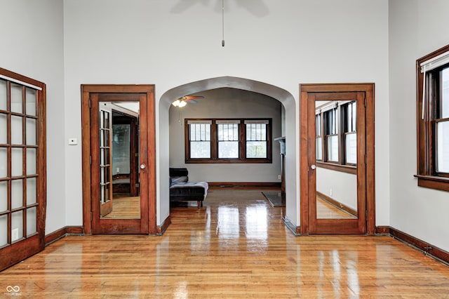 832 Noble St, Indianapolis, IN 46203 - corridor with light wood-style flooring, arched walkways, and a high ceiling