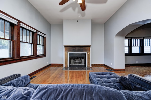 832 Noble St, Indianapolis, IN 46203 - living area with wood finished floors, ceiling fan, arched walkways, and a fireplace