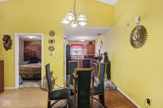 6117 Salanie Pl, Indianapolis, IN 46254 - dining space featuring a chandelier and light wood-style floors