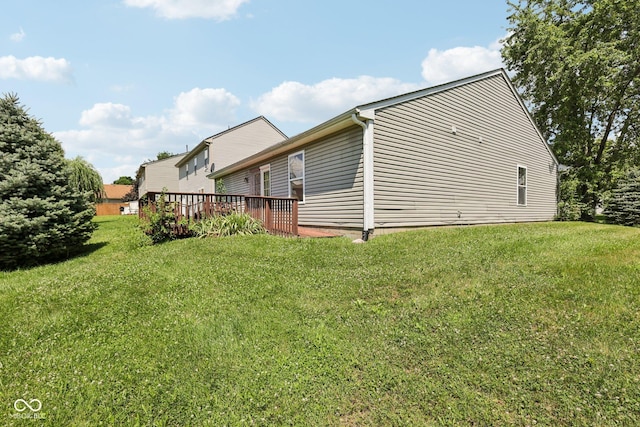 6117 Salanie Pl, Indianapolis, IN 46254 - view of side of home with a wooden deck and a yard