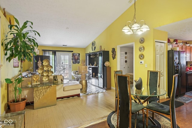 6117 Salanie Pl, Indianapolis, IN 46254 - dining space featuring a chandelier, wood finished floors, and vaulted ceiling