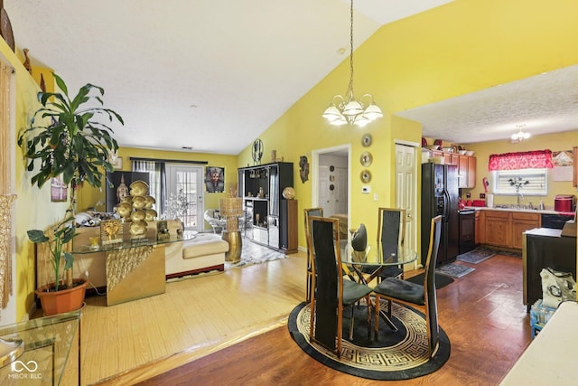 6117 Salanie Pl, Indianapolis, IN 46254 - dining area featuring a chandelier, dark wood-type flooring, and high vaulted ceiling