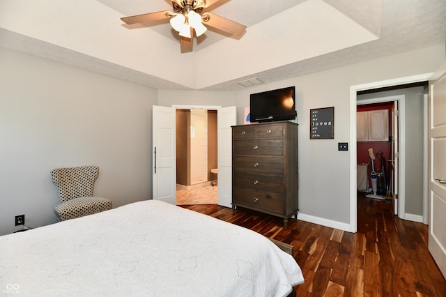 114 Sunrise Ln, Lizton, IN 46149 - bedroom with dark wood-type flooring, a tray ceiling, and ceiling fan