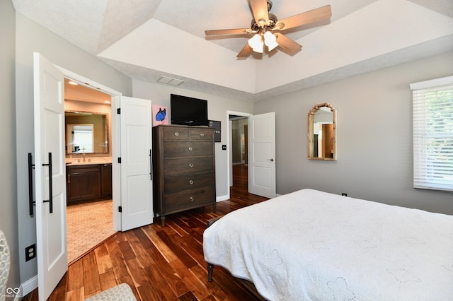 114 Sunrise Ln, Lizton, IN 46149 - bedroom with a tray ceiling, dark wood-style flooring, ensuite bath, and ceiling fan