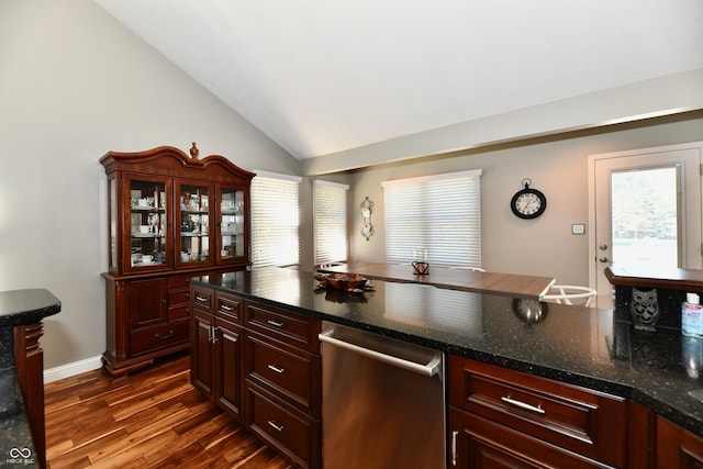 114 Sunrise Ln, Lizton, IN 46149 - kitchen with stainless steel dishwasher, dark wood-type flooring, lofted ceiling, reddish brown cabinets, and dark stone counters