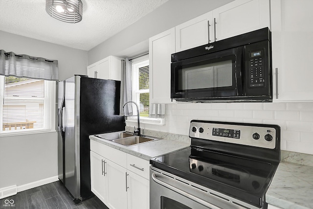 3664 S 550 E, Franklin, IN 46131 - kitchen featuring appliances with stainless steel finishes, backsplash, white cabinetry, dark wood-style flooring, and a textured ceiling