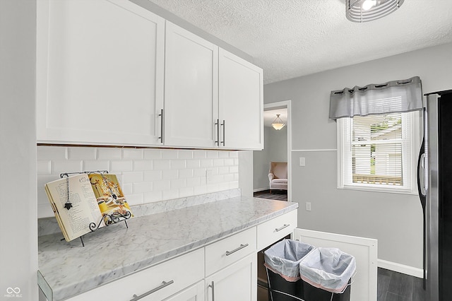 3664 S 550 E, Franklin, IN 46131 - kitchen with freestanding refrigerator, white cabinets, backsplash, light stone countertops, and a textured ceiling