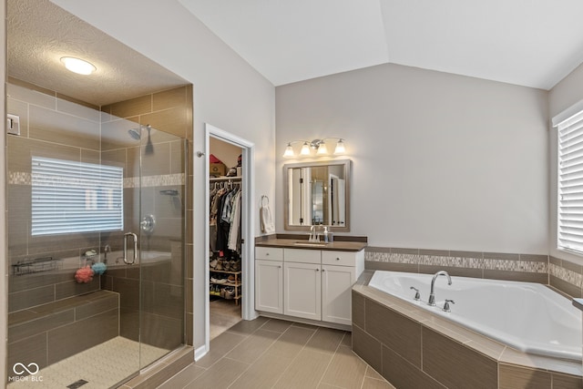 16338 Portage Trail Ln, Fortville, IN 46040 - bathroom with vanity, a bath, a shower stall, a spacious closet, and tile patterned floors