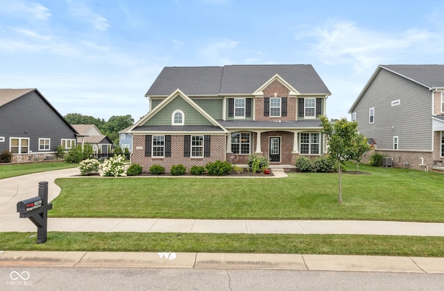 16338 Portage Trail Ln, Fortville, IN 46040 - view of front facade with brick siding, a front yard, and covered porch