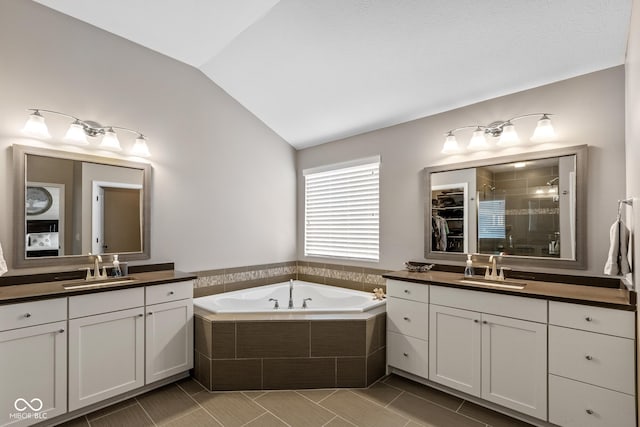 16338 Portage Trail Ln, Fortville, IN 46040 - bathroom featuring lofted ceiling, a shower stall, two vanities, a garden tub, and tile patterned flooring