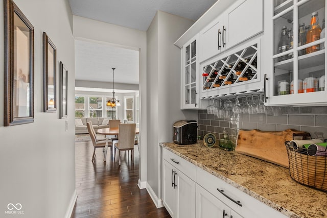 16338 Portage Trail Ln, Fortville, IN 46040 - indoor dry bar with backsplash, dark wood finished floors, and a chandelier