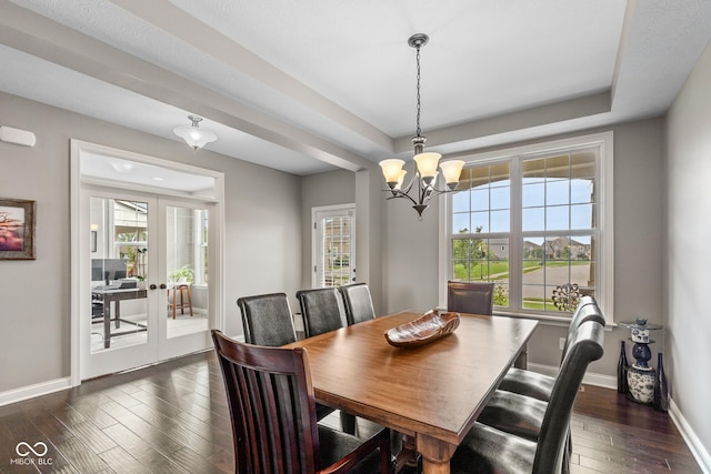 16338 Portage Trail Ln, Fortville, IN 46040 - dining area featuring a chandelier, dark wood-type flooring, a raised ceiling, and french doors