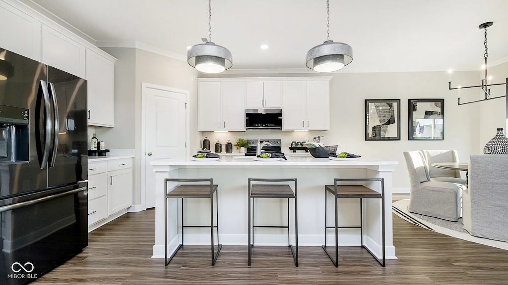 8064 Copperleaf Ln, Pendleton, IN 46064 - kitchen featuring refrigerator with ice dispenser, stainless steel microwave, stove, dark wood finished floors, and ornamental molding