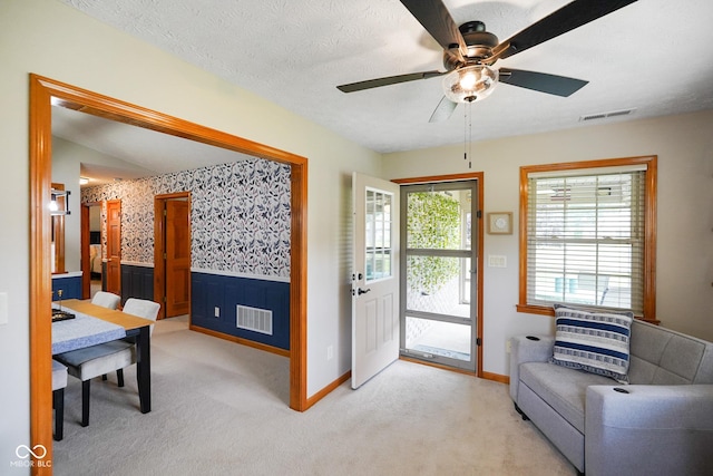 4001 Oakfield Dr, Indianapolis, IN 46237 - doorway to outside with light carpet, a wainscoted wall, a ceiling fan, and wallpapered walls