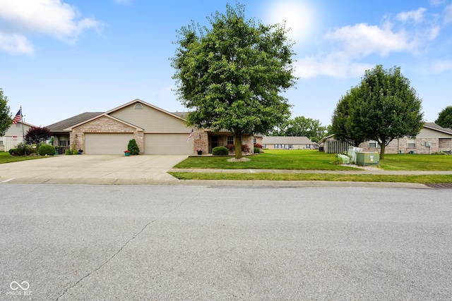 4001 Oakfield Dr, Indianapolis, IN 46237 - view of front of house featuring an attached garage, concrete driveway, brick siding, and a front lawn