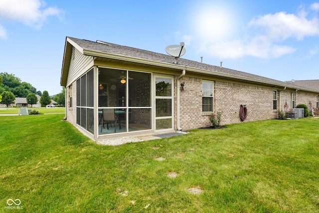 4001 Oakfield Dr, Indianapolis, IN 46237 - rear view of property with a sunroom, a yard, and brick siding