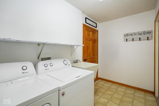 4001 Oakfield Dr, Indianapolis, IN 46237 - washroom with washer and dryer, light floors, and a textured ceiling