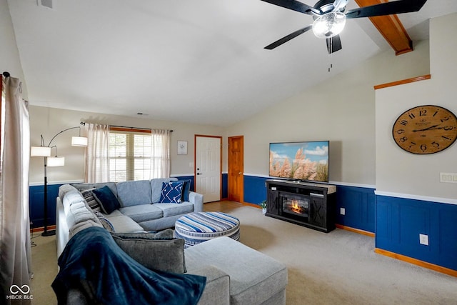 4001 Oakfield Dr, Indianapolis, IN 46237 - living room with light carpet, ceiling fan, a wainscoted wall, and a glass covered fireplace