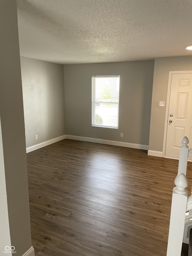 9701 W Constellation Dr, Pendleton, IN 46064 - empty room featuring a textured ceiling and dark wood-style floors